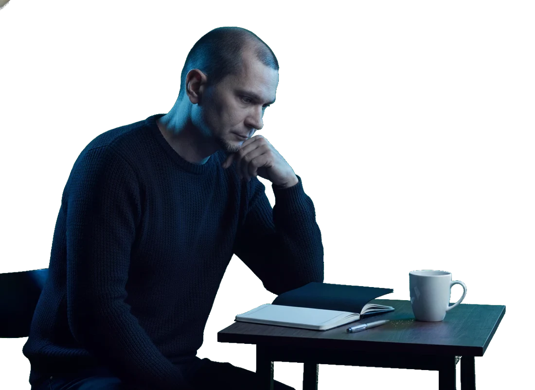 Andrei at the desk, mid-thought, coffee within reach.